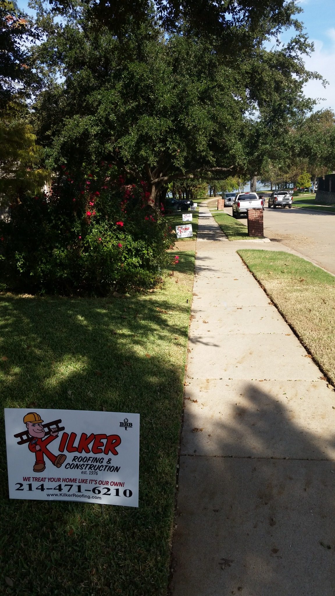 Multiple Kilker Roofing yard signs throughout a neighborhood