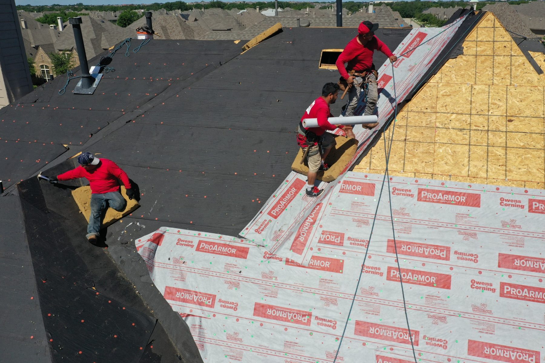 Kilker Roofing crew installing roofing underlayment on a residential roof